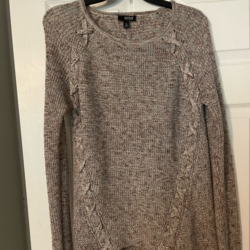 Oversized sweater with cross detailing on shoulders.
